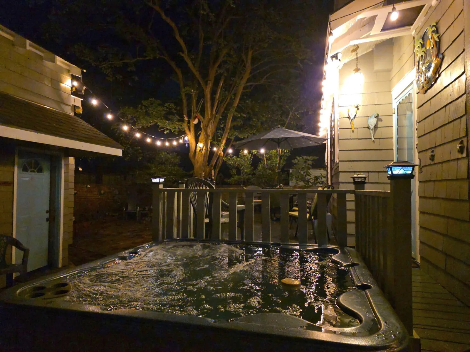Private hot tub glowing at night on the back deck